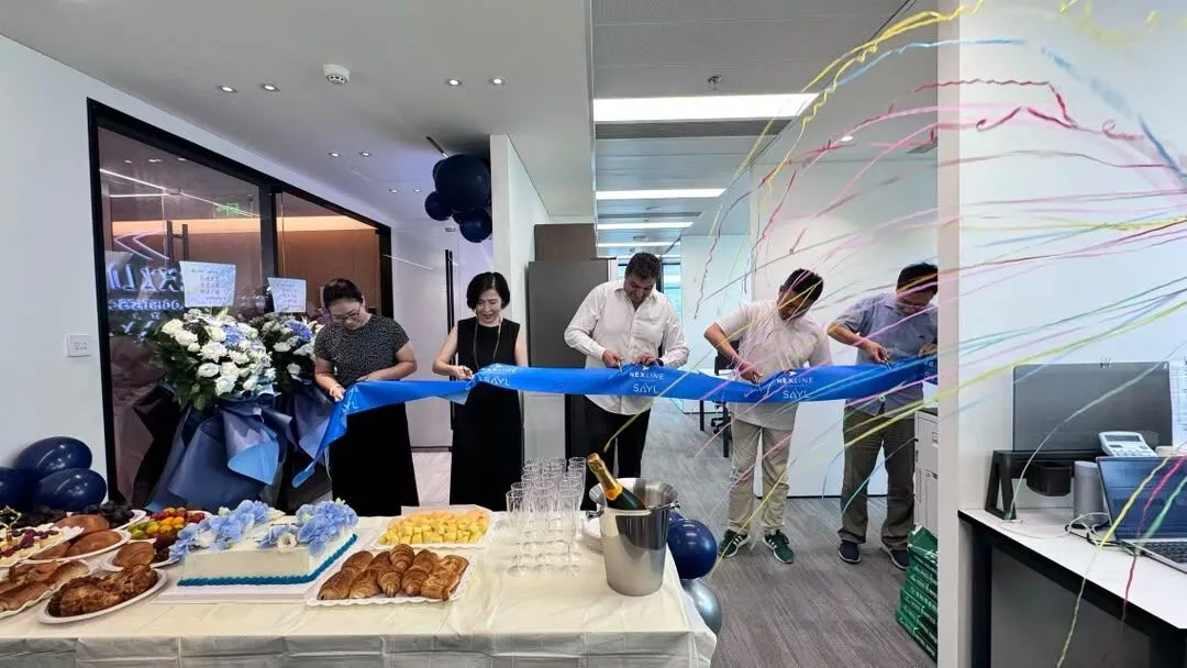 Nexline Group team inaugurating its new office in Shanghai with a ribbon-cutting ceremony.
